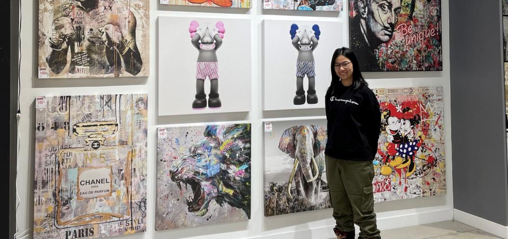 image of a person standing in front of artwork images