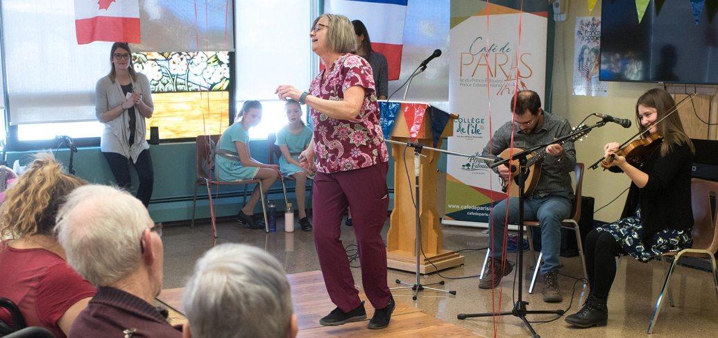 Iain MacInnes and Karine Gallant play while resident care worker Barb Feehan dances for residents of Beach Grove Home.