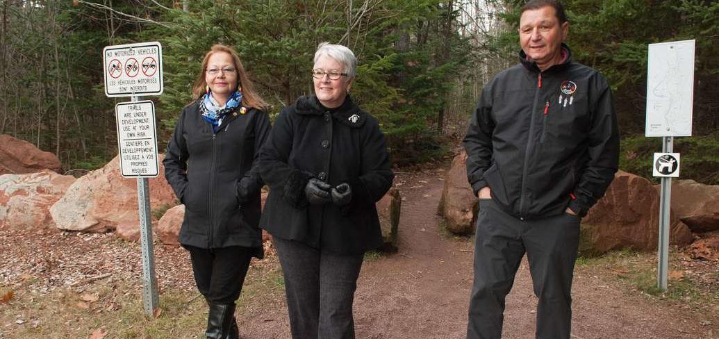 Minister Biggar and two other people walking near newly neamed trail in Bonshaw.