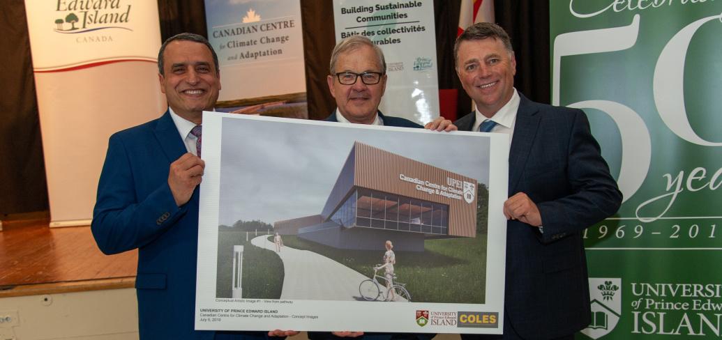UPEI president Abd-El-Aziz, PEI Premier KIng and MP MacAulay stand holding an artists rendition of the new research centrer