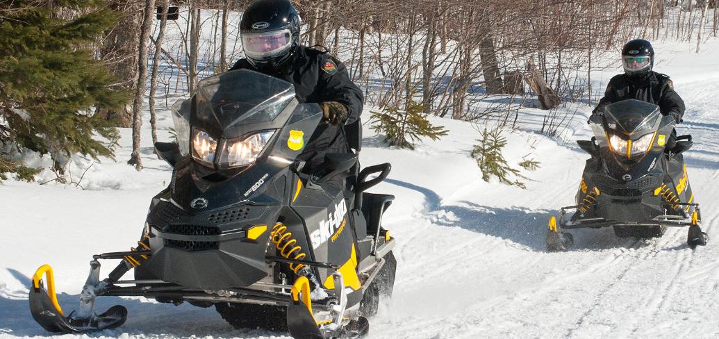 PEI’s Conservation Officers patrolling on snowmobiles. 
