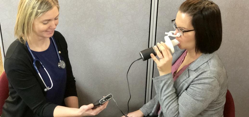 Heather Cyr administers a spirometry test.