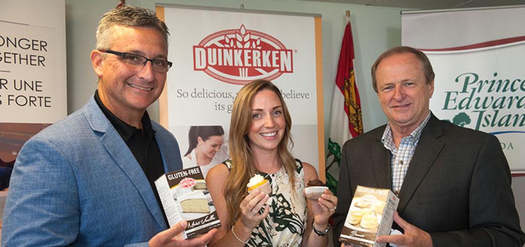 Three people holding Duinkerken food products