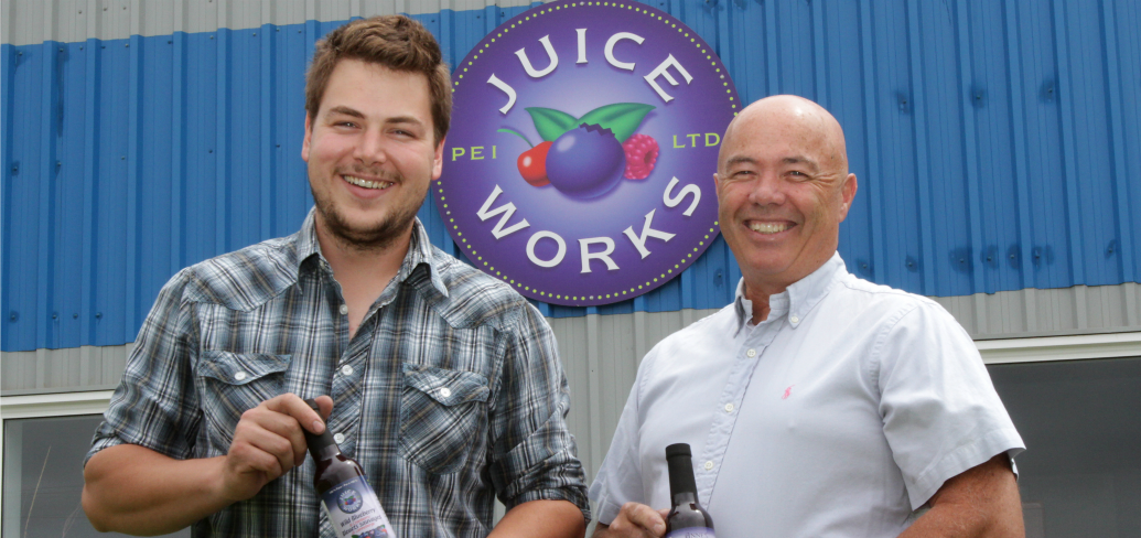 PEI Juice Works General Manager Jackson Platts, and President Denton Ellis hold bottles of the company's signature blueberry juice.