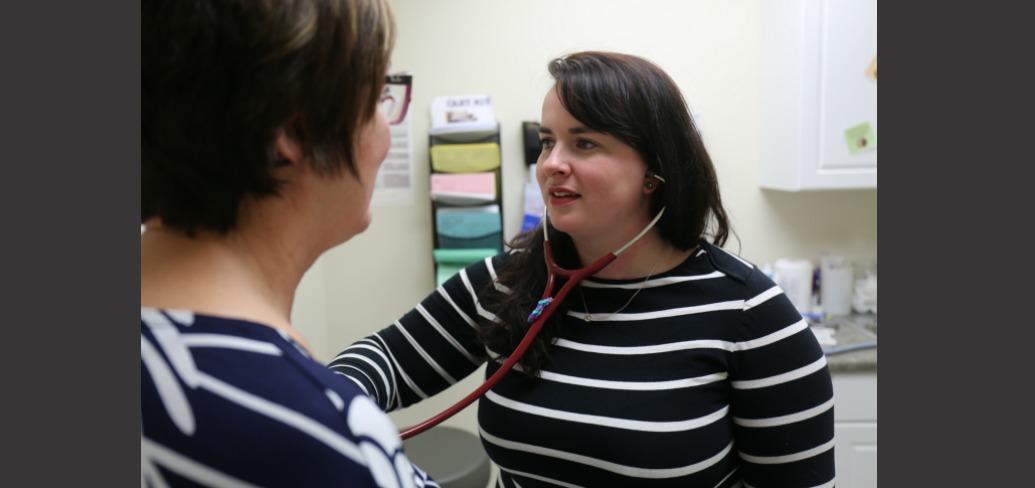 Nurse Practitioner Melinda Ells is shown with a patient. 