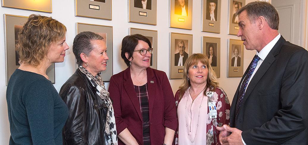 Nurses Jill Anne McDowall, Cynthia Bryanton, Anita MacKenzie and Debbie Flood-Vickerson speak with Minister Mitchell about nursing on PEI