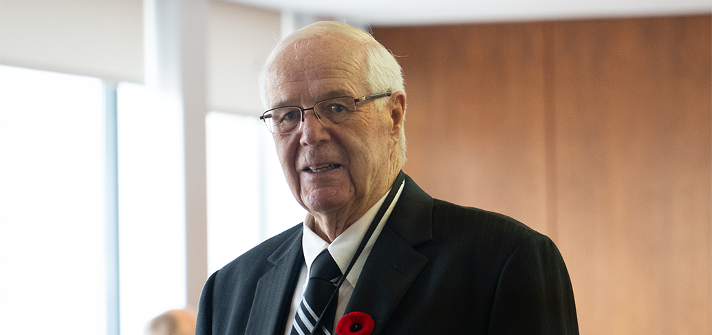 Head and shoulder photo of former Premier Jim Lee. He is wearing a dark suit and a poppy.