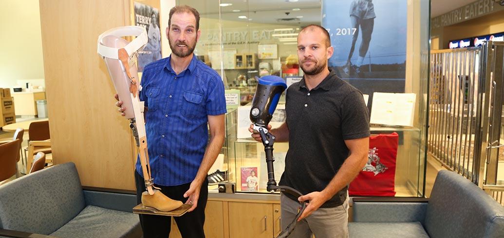 QEH prosthetic technicians Paul Hoar and Gabe Arsenault display prosthetic legs