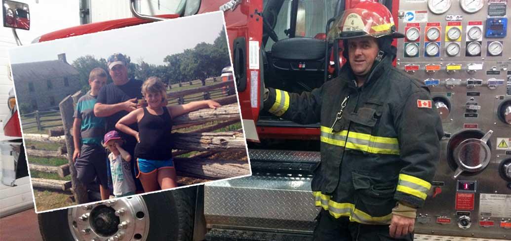Firefighter stands with family and company truck.