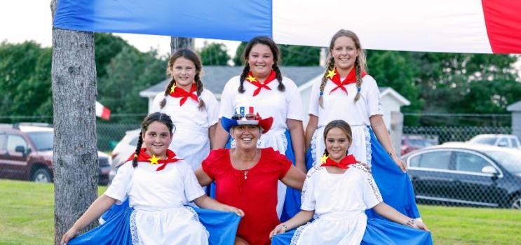people dressed in Acadian colours