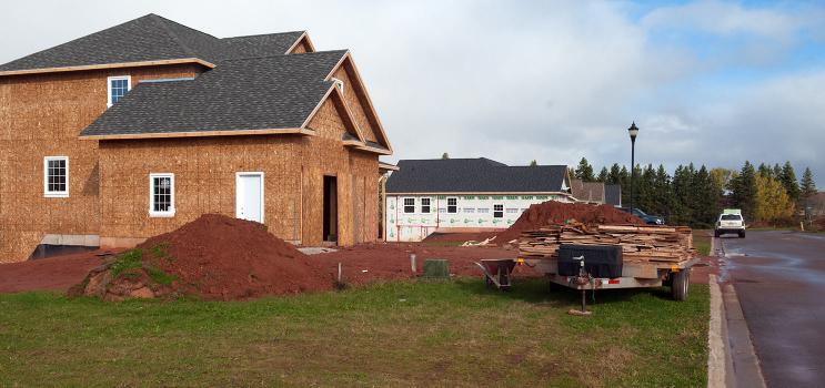 A construction site with a house being built. 