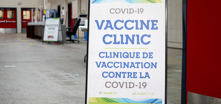 Image of a sandwich board sign for a Covid 19 Vaccinc clinic