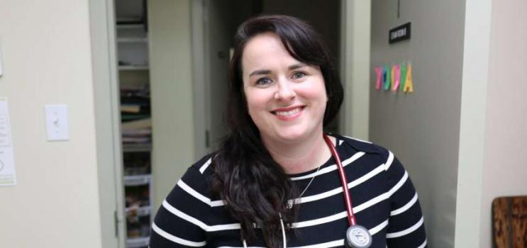 Nurse practitioner with a big smile in clinical setting on PEI
