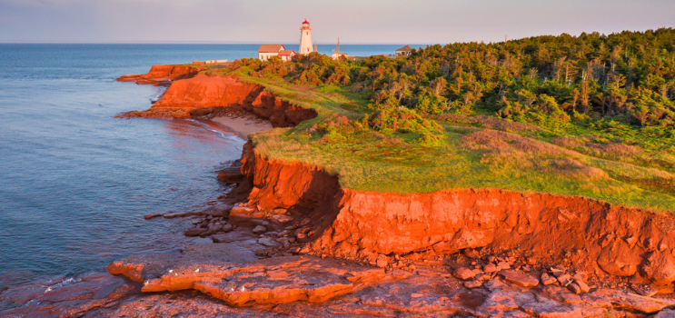 Image of red cliffs and lighthouse on Prince Edward Island