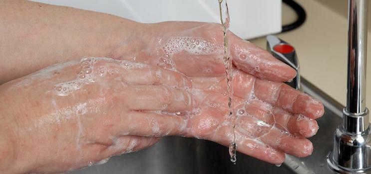 Image of female washing her hands