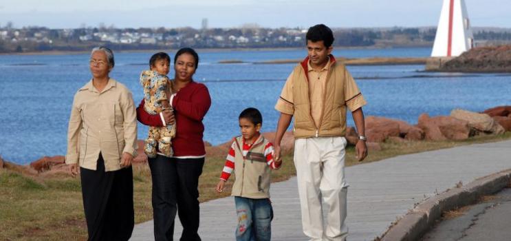 Multi-generational family walks on the boardwalk near Victoria Park