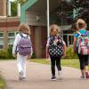 Three children walking into school