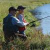 Father and son fishing in PEI river