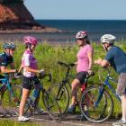 Group of four biking on cycling lane in PEI National Park
