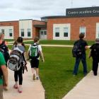 A group of students walk toward the entrace of Ecole sur Mer in South Rustico