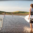 Image of male carrying paddle board to PEI beach with thumbnail image of physician as an insert