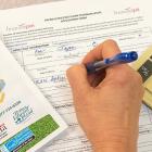 woman completing application for Energy Efficiency Loan program