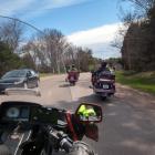 Image taken from viewpoint of motorcycle driver on rural PEI road with other motorcycles in front and car in opposing lane