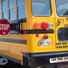 school bus with amber and red lights flashing