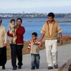 Multi-generational family walks on the boardwalk near Victoria Park