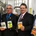 Photo shows four men holding packaged ADL cheese products