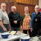 Members stand behind a cooking counter from the Benevolent Irish Society Taste of Irish Baking class
