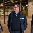 Premier MacLauchlan and Minister MacDonald standing in facility with Ron MacDougall