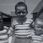 Carter Jeffrey stands in the middle of two of his brothers in a photo taken when they were children.