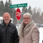 Minister Biggar and thre other people stand in front of the Clyde Minard Way street sign.