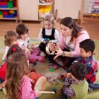 image of a teacher reading to children in a circle