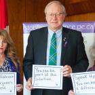 Three people holding signs reminding us to speak out against family violence