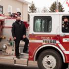 image of three people standing on a fire truck