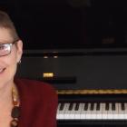 Dr. Janice Gillis sits at her piano