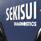 Two people standing in front of a sign at Sekisui Diagnostics