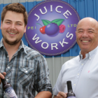 PEI Juice Works General Manager Jackson Platts, and President Denton Ellis hold bottles of the company's signature blueberry juice.