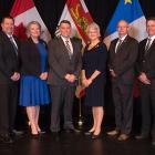 Members of the new government cabinet, standing in a row with the Lieutenant Governor
