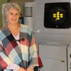 Dawn MacIsaac sits by one of the older Linear Accelerator's at the PEI Cancer Treatment Center
