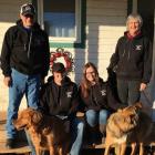 MacKinnon family and their dogs on the outside front step of their home