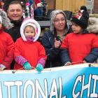 Children and adults stand behind a banner for 2018 National Child Day parade