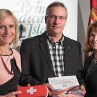 Photo shows Dr. Heather Morrisson holding a Naxolone kit, Minister Robert Henderson holding the plan, and Karen MacDonald of Justice and Public Safety.
