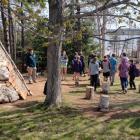 image of a group of students in the woods near a teepee