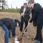 Environment Minister Robert Mitchell and Agriculture Minister Alan McIsaac bury a pair of white cotton brief to test the quality of Island soil