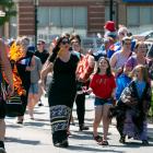 A tintamarre parade of people celebrating National Acadian Day in Charlottetown