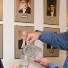 Photo shows Environmental Advisory Council Chair Dean Stewart pouring a glass of water for Communities, Land and Environment Minister Robert Mitchell and 