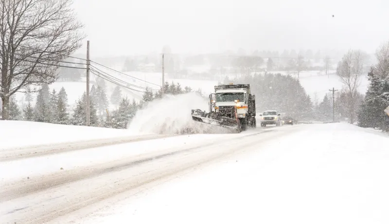 A Department operated snowplow clearing snow off of a roadway.